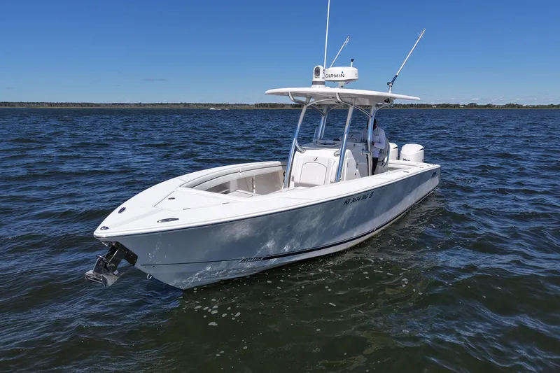 Slide: The Image of 2014 Jupiter 30 FS boat on open water under clear blue sky. - 2