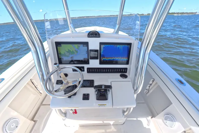 Slide: The Image of 2014 Jupiter 30 FS boat console with navigation screens on open water. - 20