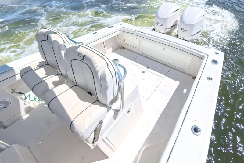 Slide: The Image of 2014 Jupiter 30 FS boat with dual engines and cushioned seating on open water. - 23