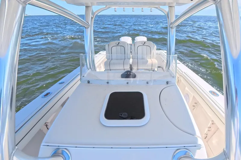 Slide: The Image of 2014 Jupiter 30 FS boat on open water, featuring sleek design and comfortable seating. - 24