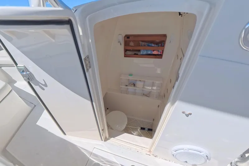 Slide: The Image of 2014 Jupiter 30 FS boat interior with open storage compartment and visible amenities. - 25