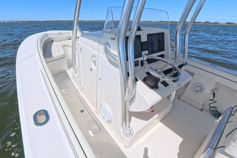 Slide: The Image of 2014 Jupiter 30 FS boat interior with steering console on open water. - 26