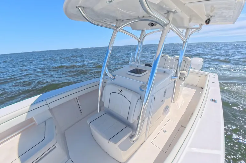 Slide: The Image of 2014 Jupiter 30 FS boat on open water, featuring sleek design and spacious deck. - 27