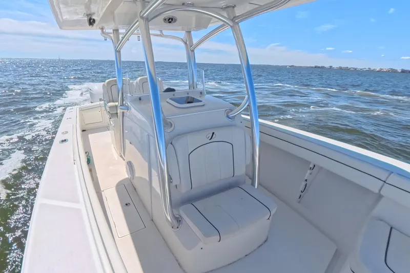 Slide: The Image of 2014 Jupiter 30 FS boat cruising on open water under clear blue skies. - 28