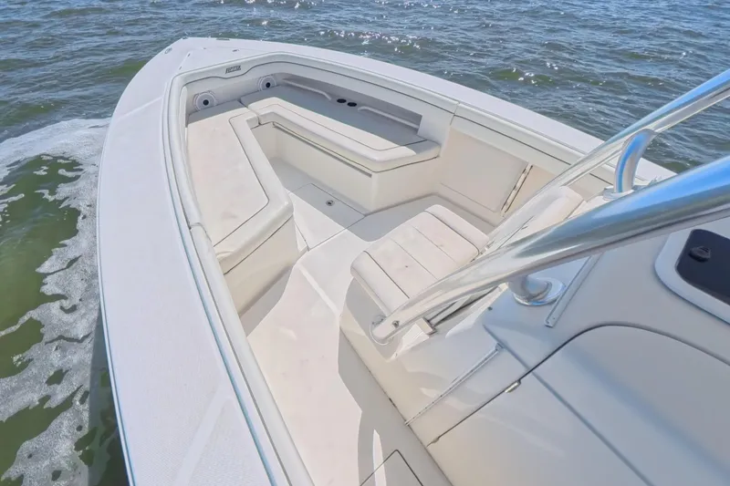 Slide: The Image of 2014 Jupiter 30 FS boat interior with cushioned seating on open water. - 29