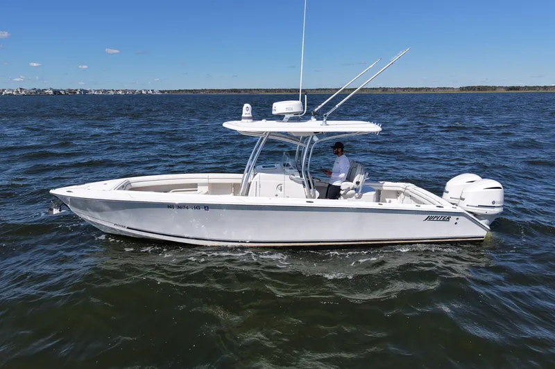 Slide: The Image of 2014 Jupiter 30 FS boat cruising on open water under clear blue sky. - 3