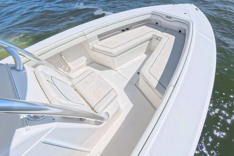 Slide: The Image of 2014 Jupiter 30 FS boat interior with white seating on calm water. - 30