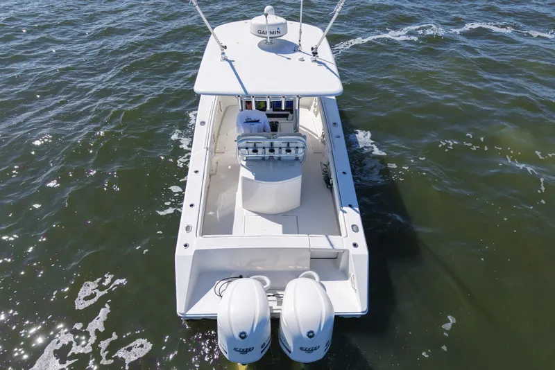 Slide: The Image of 2014 Jupiter 30 FS boat on water, aerial view, twin engines visible. - 5