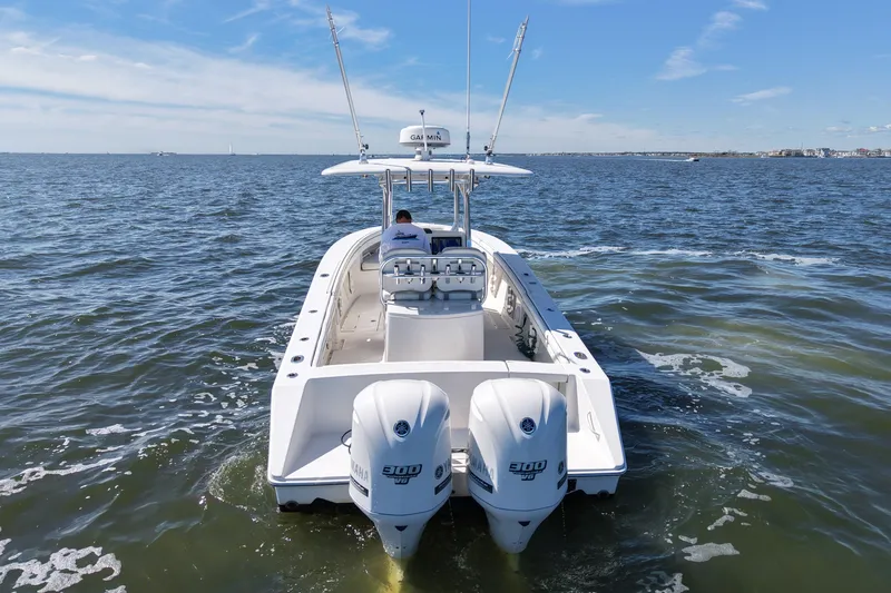 Slide: The Image of 2014 Jupiter 30 FS boat cruising on open water with twin Yamaha engines. - 6