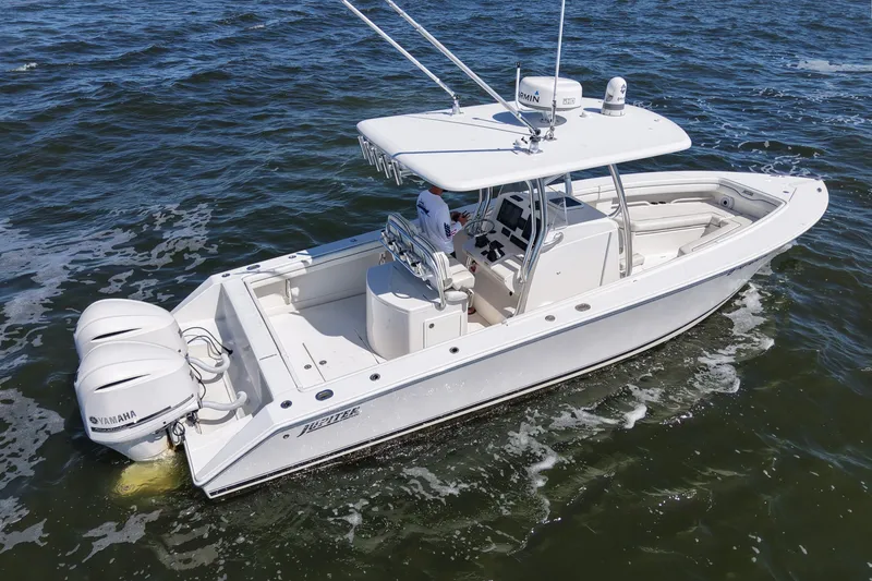 Slide: The Image of 2014 Jupiter 30 FS boat with twin Yamaha engines cruising on the water. - 7