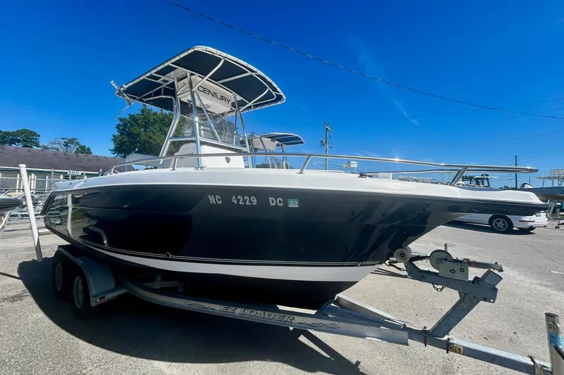 Slide: The Image of 2006 Century 2200 Center Console boat on trailer under clear blue sky. - 2