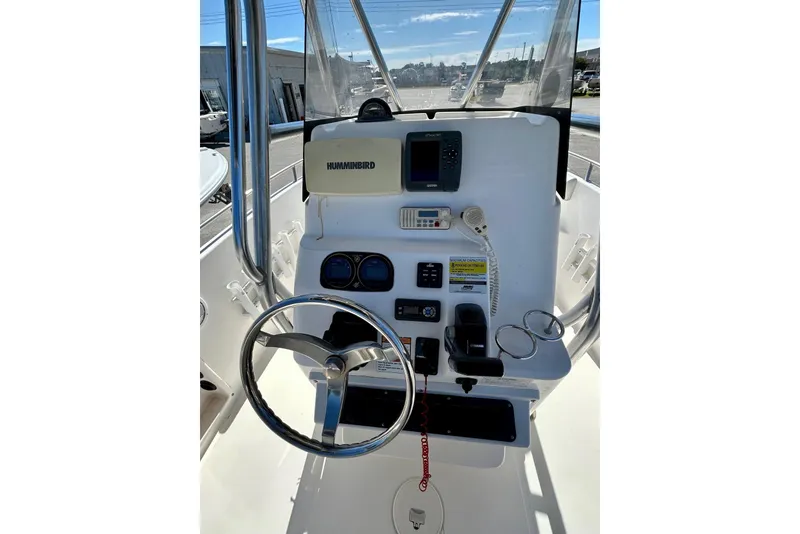 Slide: The Image of 2006 Century 2200 Center Console boat dashboard with steering wheel and navigation equipment. - 3