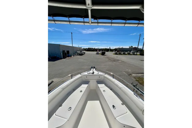 Slide: The Image of 2006 Century 2200 Center Console boat, docked, with clear blue sky and industrial background. - 4