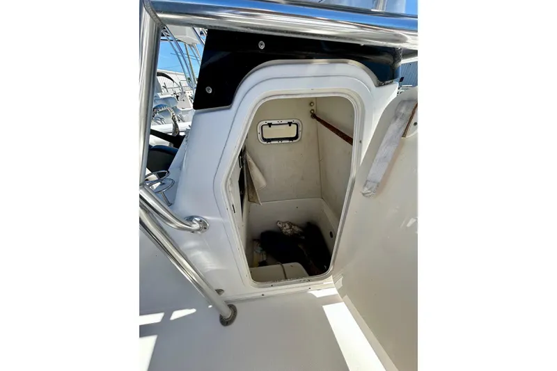 Slide: The Image of 2006 Century 2200 Center Console boat storage compartment with open door. - 6