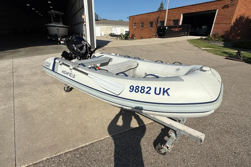 Slide: The Image of 2020 Highfield Classic 310 inflatable boat on trailer outside a garage. - 3
