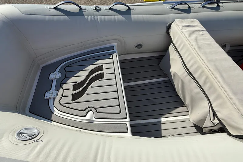 Slide: The Image of 2020 Highfield Classic 310 inflatable boat interior with cushioned seating and storage. - 5