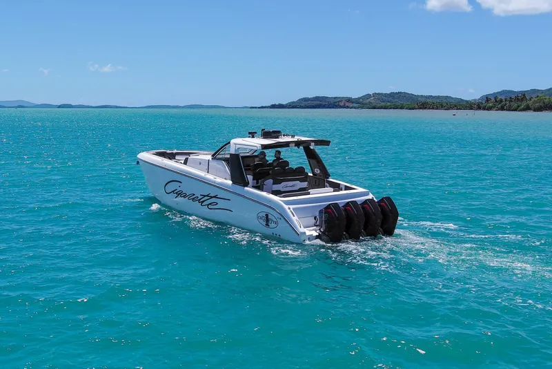 Slide: The Image of 2025 Cigarette 42 Auroris boat cruising on turquoise waters under clear blue sky. - 14