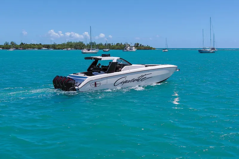 Slide: The Image of 2025 Cigarette 42 Auroris boat cruising on turquoise waters with sailboats in the background. - 15