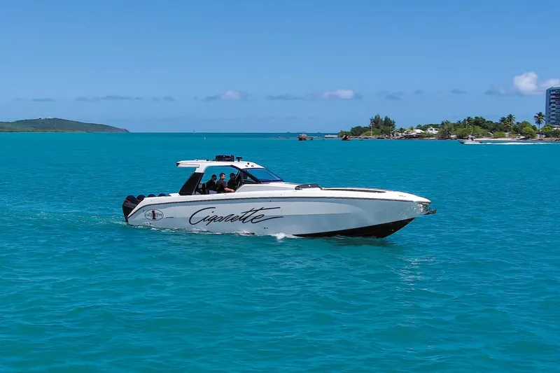 Slide: The Image of 2025 Cigarette 42 Auroris boat cruising on turquoise waters near a tropical island. - 16