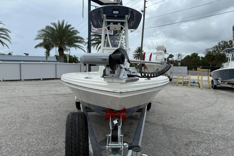 Slide: The Image of 2026 Pathfinder 2300 HPS boat on trailer, parked outdoors with palm trees. - 10