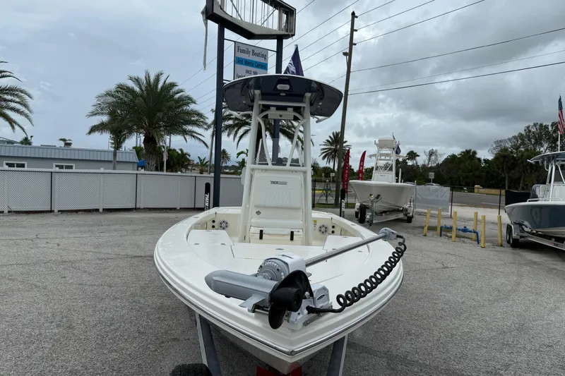 Slide: The Image of 2026 Pathfinder 2300 HPS boat displayed outdoors with palm trees and overcast sky. - 11