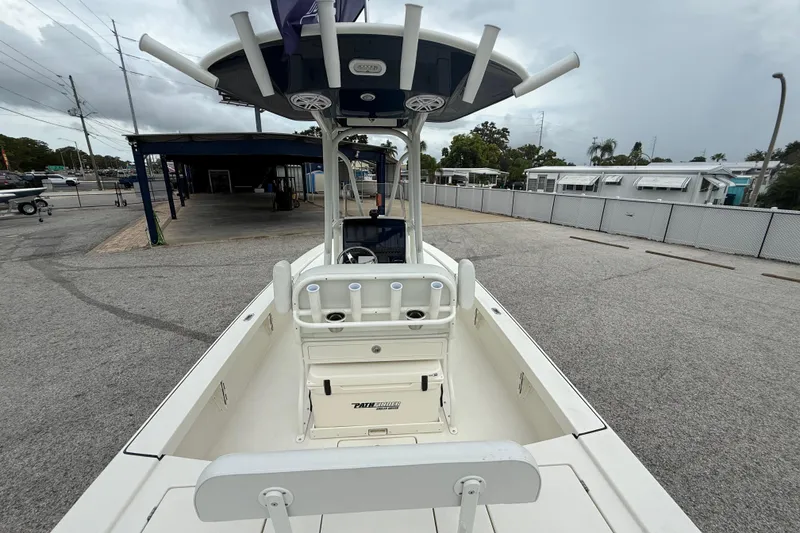 Slide: The Image of 2026 Pathfinder 2300 HPS boat, docked in a marina, showcasing spacious deck and seating. - 13