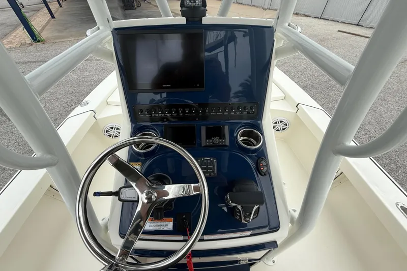 Slide: The Image of 2026 Pathfinder 2300 HPS boat console with steering wheel and navigation display. - 15