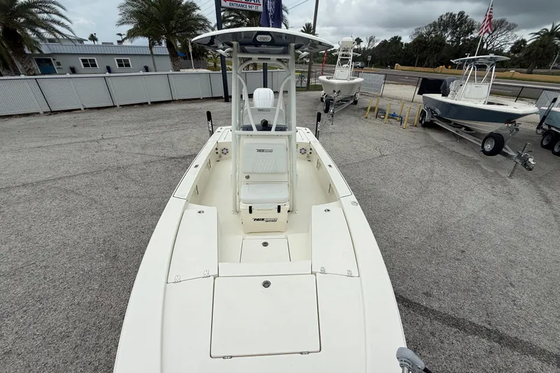 Slide: The Image of 2026 Pathfinder 2300 HPS boat displayed in outdoor showroom with other boats. - 19