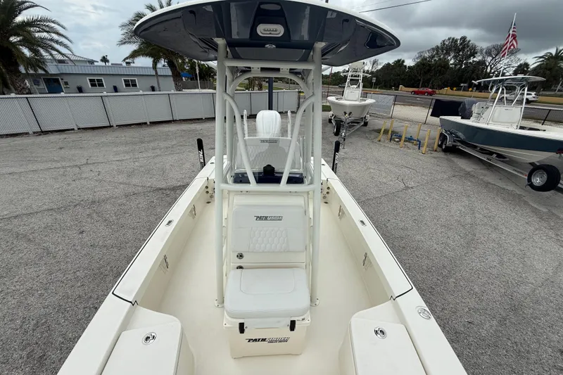 Slide: The Image of 2026 Pathfinder 2300 HPS boat with T-top, parked outdoors on concrete. - 20