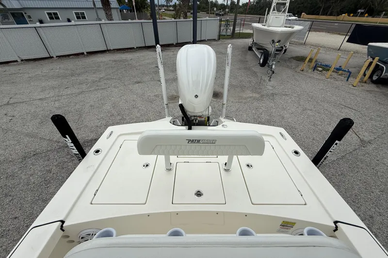 Slide: The Image of 2026 Pathfinder 2300 HPS boat, rear view, showcasing deck and motor in a marina setting. - 22