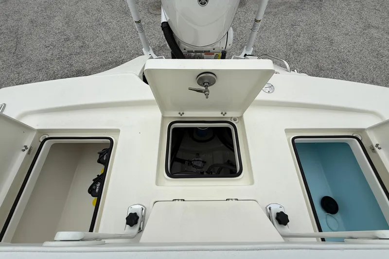 Slide: The Image of Pathfinder 2300 HPS 2026 boat storage compartments and engine view. - 24