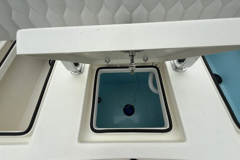 Slide: The Image of 2026 Pathfinder 2300 HPS boat interior with open storage compartment and seating. - 25