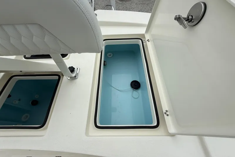 Slide: The Image of Pathfinder 2300 HPS 2026 boat storage compartments with open lids and seating. - 27