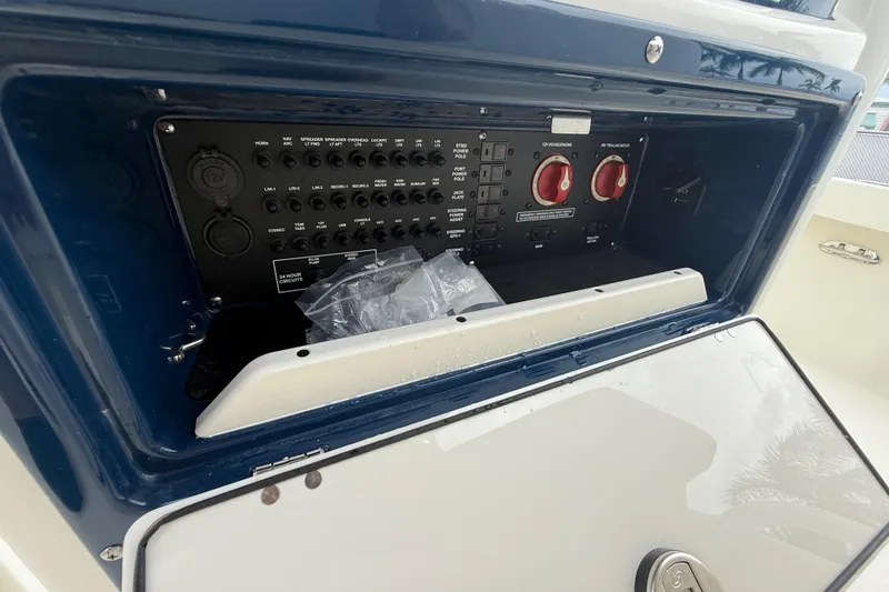 Slide: The Image of Control panel of a 2026 Pathfinder 2300 HPS boat, featuring switches and dials. - 29