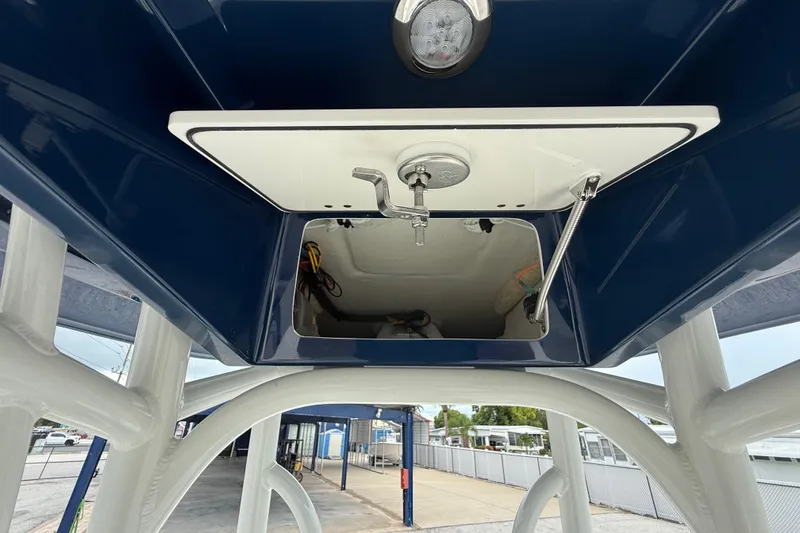 Slide: The Image of 2026 Pathfinder 2300 HPS boat interior view, showcasing storage compartment and lighting. - 32