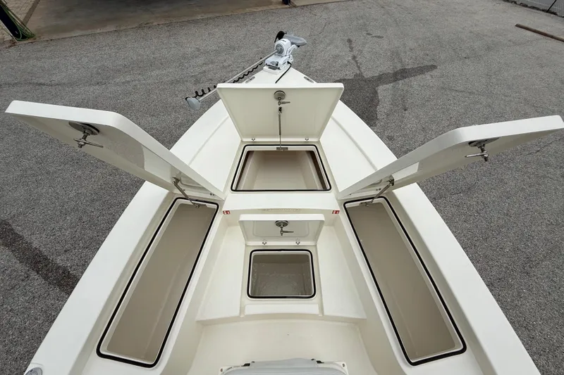 Slide: The Image of 2026 Pathfinder 2300 HPS boat with open storage compartments on deck. - 36