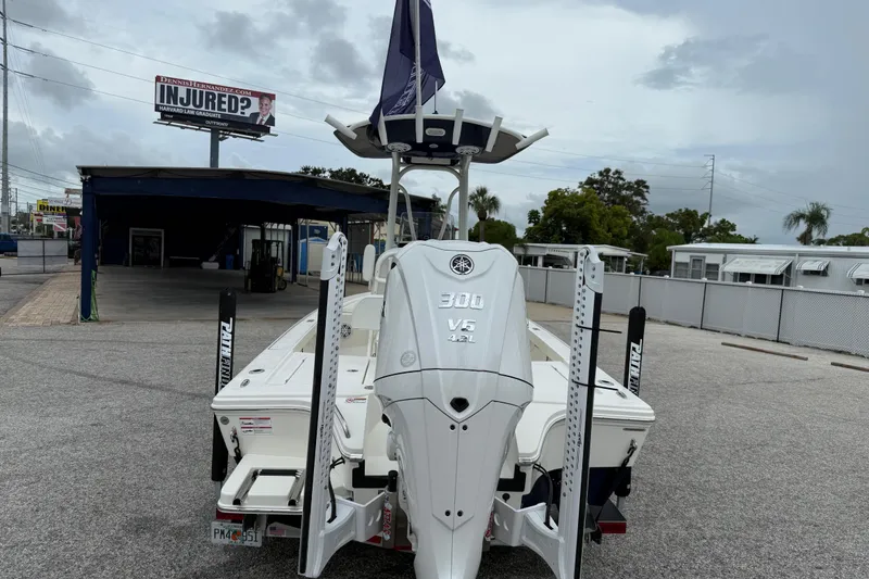 Slide: The Image of 2026 Pathfinder 2300 HPS boat with Yamaha 300 V6 engine in parking lot. - 4
