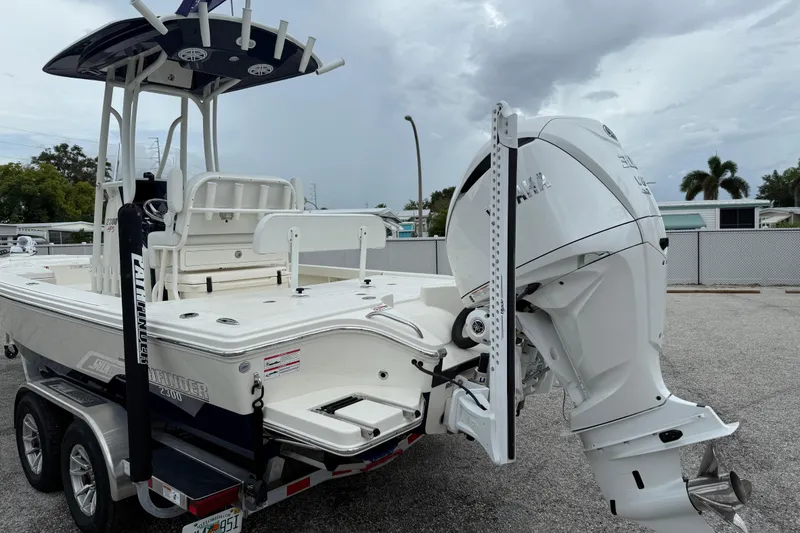Slide: The Image of 2026 Pathfinder 2300 HPS boat with Yamaha outboard motor on trailer, parked outdoors. - 5