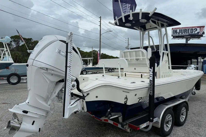 Slide: The Image of 2026 Pathfinder 2300 HPS boat with Yamaha engine on a trailer, parked outdoors. - 6