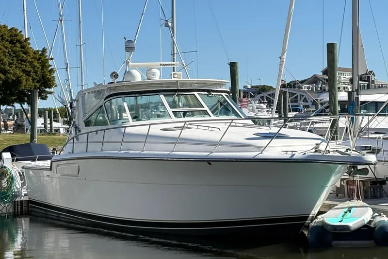The Image of 1996 Tiara 4300 Open yacht docked at marina, clear sky background. - 0