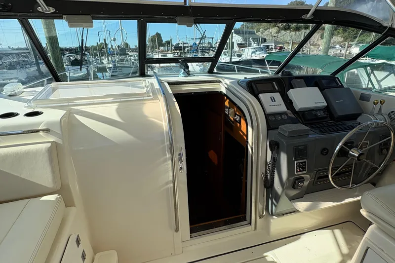 Slide: The Image of 1996 Tiara Yachts 4300 Open cockpit with steering wheel and navigation equipment. - 10