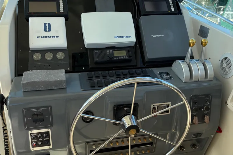 Slide: The Image of 1996 Tiara 4300 Open helm with navigation equipment and steering wheel. - 13