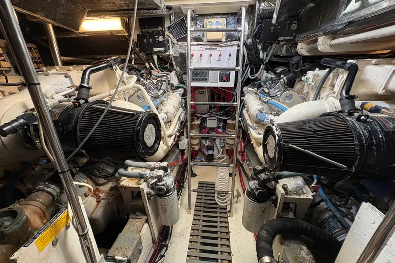 Slide: The Image of Engine room of a 1996 Tiara 4300 Open yacht, showcasing dual engines and control panel. - 27