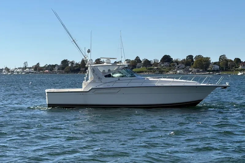 Slide: The Image of 1996 Tiara Yachts 4300 Open cruising on a sunny day near the shoreline. - 11