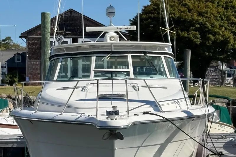 Slide: The Image of 1996 Tiara 4300 Open yacht docked at a marina, front view. - 3