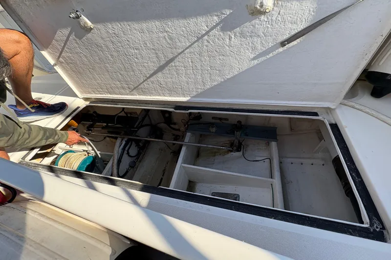Slide: The Image of Open hatch of a 1996 Tiara 4300 Open boat showing storage compartment. - 32