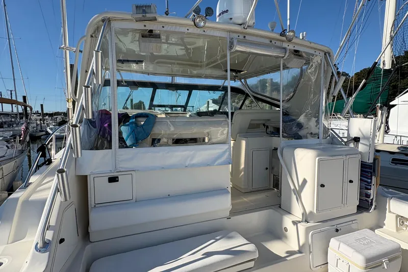 Slide: The Image of 1996 Tiara 4300 Open yacht with spacious cockpit and clear enclosure at marina. - 6