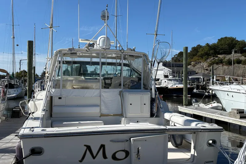 Slide: The Image of 1996 Tiara 4300 Open yacht docked at marina, clear sky, surrounded by other boats. - 7
