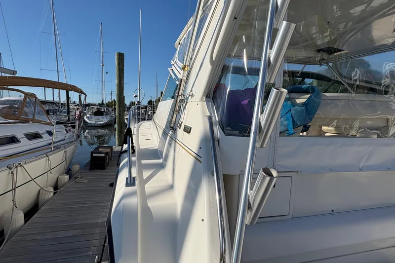 Slide: The Image of 1996 Tiara 4300 Open yacht docked at marina under clear blue sky. - 8