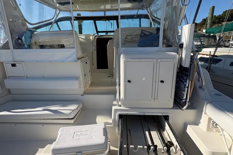 Slide: The Image of 1996 Tiara 4300 Open yacht interior with seating, storage, and fishing rod holders. - 9